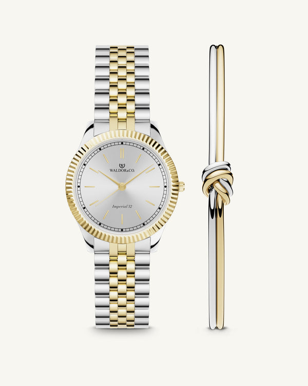 A round womens watch in silver and 22k gold from Waldor & Co. with silver sunray dial and a second hand. Seiko movement. The model is Imperial 32 Positano 32mm.
