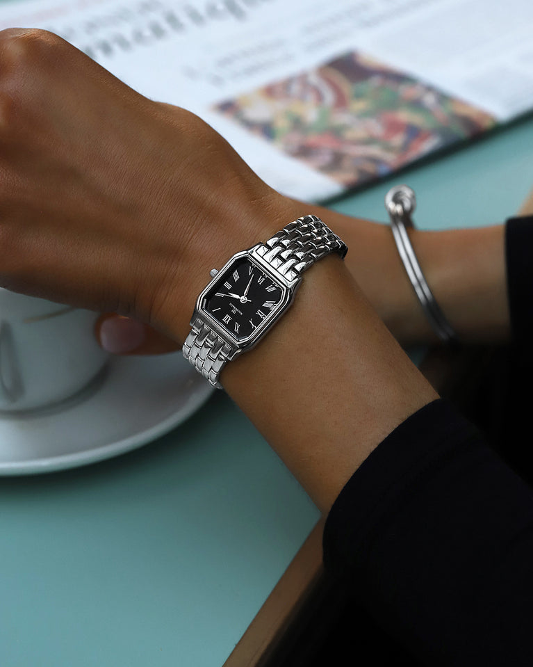 A square womens watch in Rhodium-plated 316L stainless steel from Waldor & Co. with black Diamond Cut Sapphire Crystal glass dial. Seiko movement. The model is Eternal 22 Bellagio.