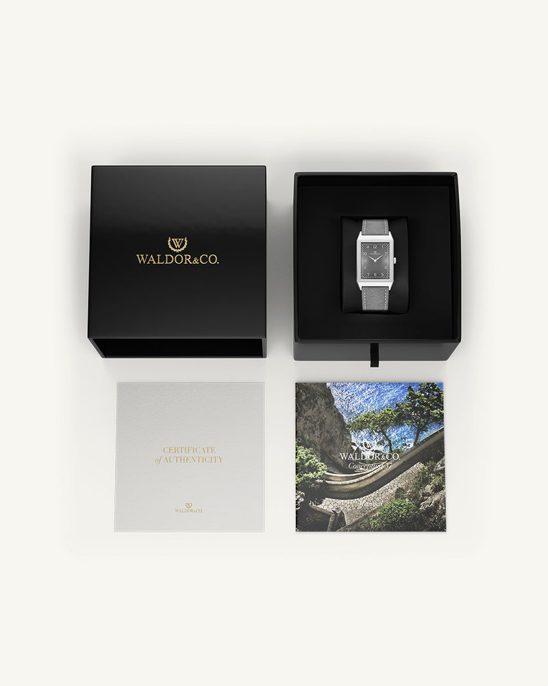 A square mens watch in Rhodium-plated 316L stainless steel from Waldor & Co. with grey guilloche dial. Miyota movement. Leather strap. The model is Conceptual 37 Cap Ferrat.