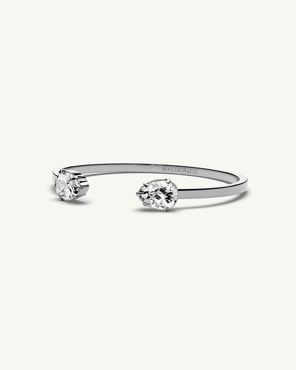 A polished stainless steel bangle in 14k gold from Waldor & Co. One size. The model is Crystal Bangle Polished.