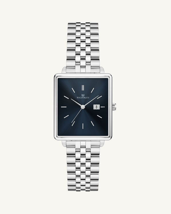 A square womens watch in silver from WALDOR & CO. with blue sunray dial and a second hand. The model is Delight 32 Chelsea 28x32mm.