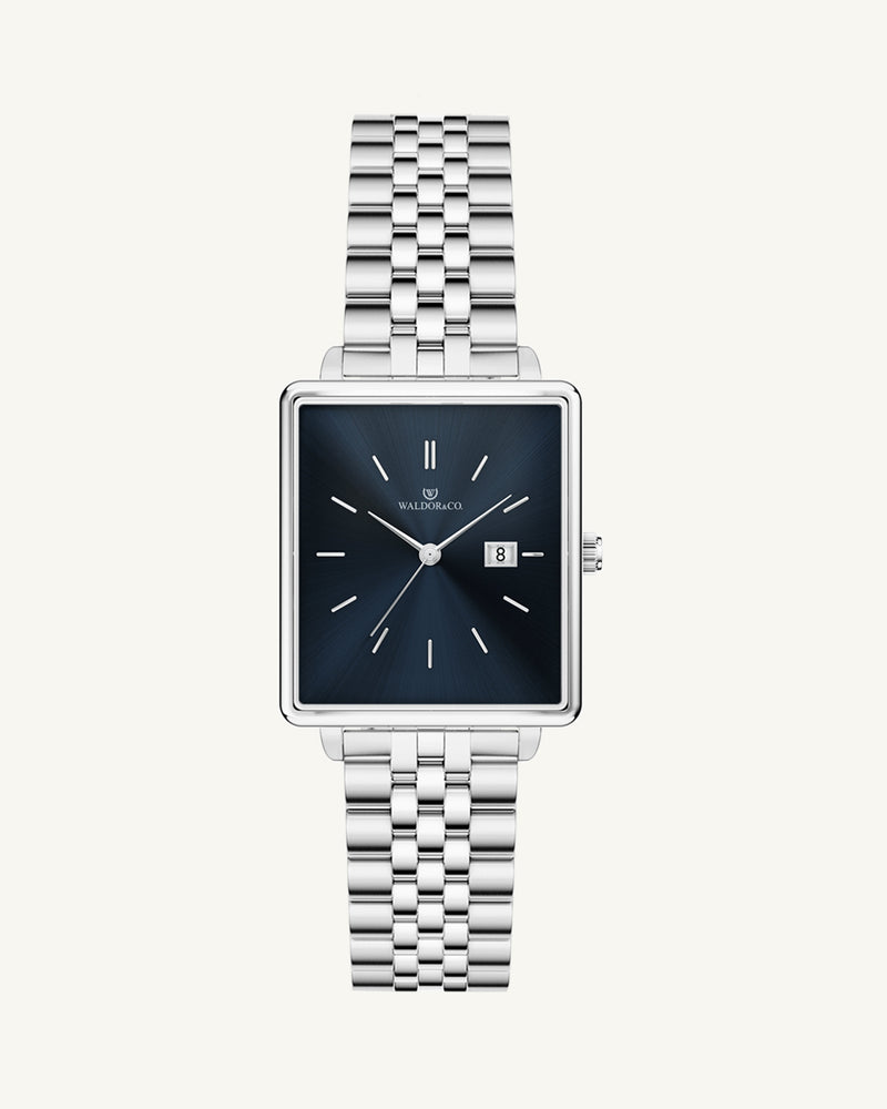 A square womens watch in silver from WALDOR & CO. with blue sunray dial and a second hand. The model is Delight 32 Chelsea 28x32mm.