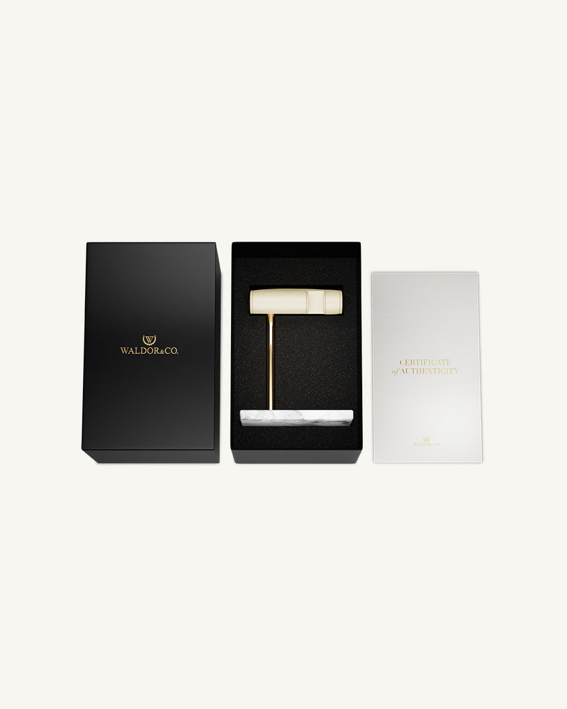 A Watch Stand in 14k gold-plated stainless steel and marble from Waldor & Co. The model is Watch Stand.