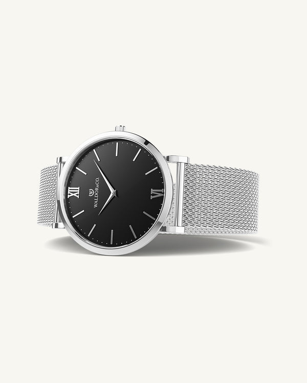 A round watch in silver from Waldor & Co. with black dial. Seiko movement. The model is Original 36 Côte d'Azur 36mm.