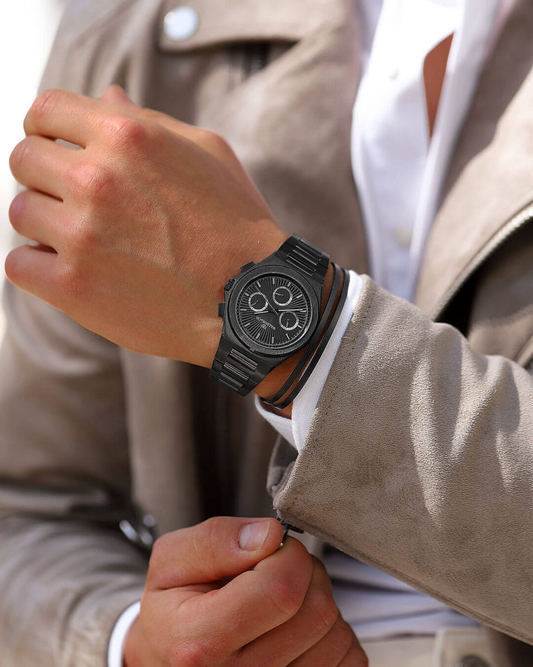 A round mens watch in black Rhodium-plated 316L stainless steel from Waldor & Co. with black sunray dial and luminous hands. Seiko movement. The model is Inceptive 40 Azores.