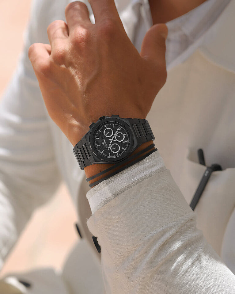 A round mens watch in black Rhodium-plated 316L stainless steel from Waldor & Co. with black sunray dial and luminous hands. Seiko movement. The model is Inceptive 40 Azores.