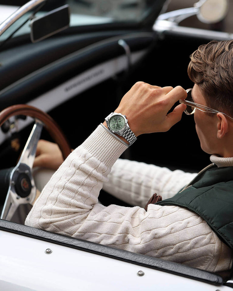 A round mens watch in rhodium-plated silver from Waldor & Co. with green sunray dial and a second hand. Seiko movement. The model is Chrono 39 Porto Cervo.