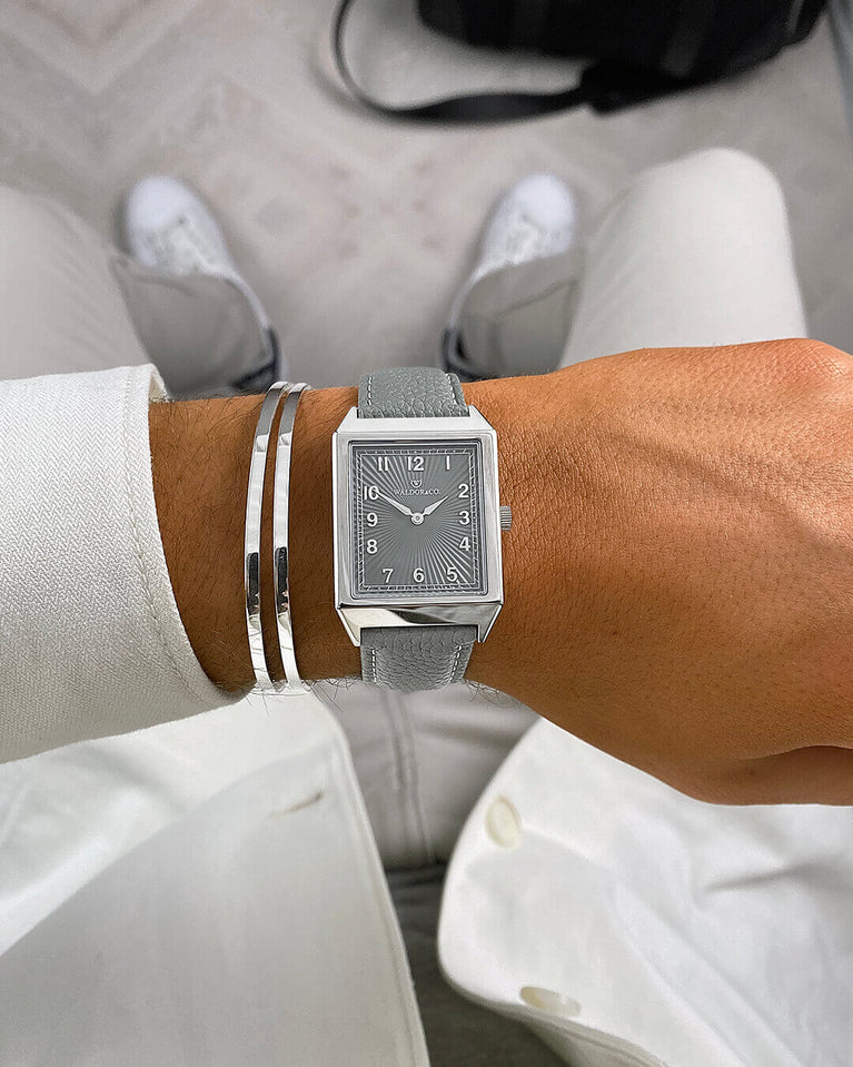 A square mens watch in Rhodium-plated 316L stainless steel from Waldor & Co. with grey guilloche dial. Miyota movement. Leather strap. The model is Conceptual 37 Cap Ferrat.
